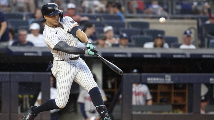 Jun 22, 2024; Bronx, New York, USA;  New York Yankees designated hitter Giancarlo Stanton (27) hits a double against the Atlanta Braves in the fourth inning at Yankee Stadium. Mandatory Credit: Wendell Cruz-USA TODAY Sports