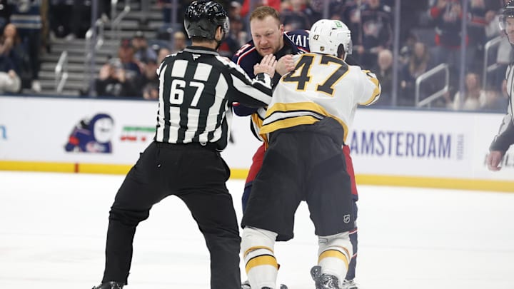 Mar 29, 2026; Columbus, Ohio, USA; Columbus Blue Jackets center Mathieu Olivier (24) and Boston Bruins center Mark Kastelic (47) fight during the first period at Nationwide Arena. Mandatory Credit: Russell LaBounty-Imagn Images