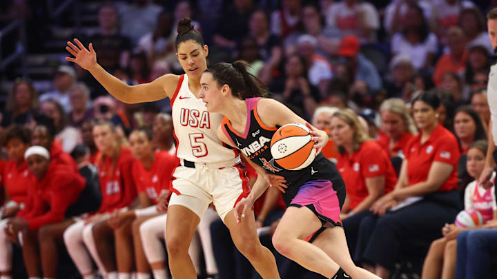 Jul 20, 2024; Phoenix, AZ, USA; Team WNBA guard Caitlin Clark (22) against USA Women's National Team player Kelsey Plum (5) at Footprint Center. Mandatory Credit: Mark J. Rebilas-Imagn Images