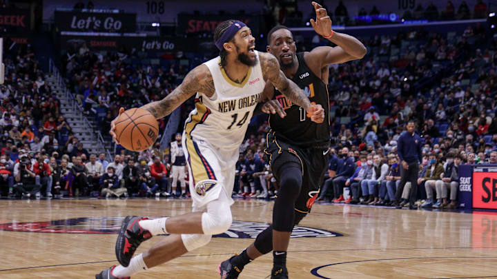Feb 10, 2022; New Orleans, Louisiana, USA; New Orleans Pelicans forward Brandon Ingram (14) dribbles the ball against Miami Heat center Bam Adebayo (13) during the second half at the Smoothie King Center. Mandatory Credit: Stephen Lew-Imagn Images