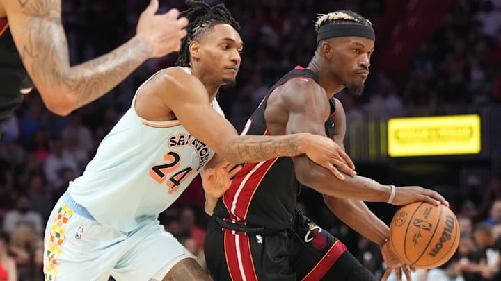 Jan 19, 2025; Miami, Florida, USA;  San Antonio Spurs guard Devin Vassell (24) defends Miami Heat forward Jimmy Butler (22) during the second half at Kaseya Center. Mandatory Credit: Jim Rassol-Imagn Images