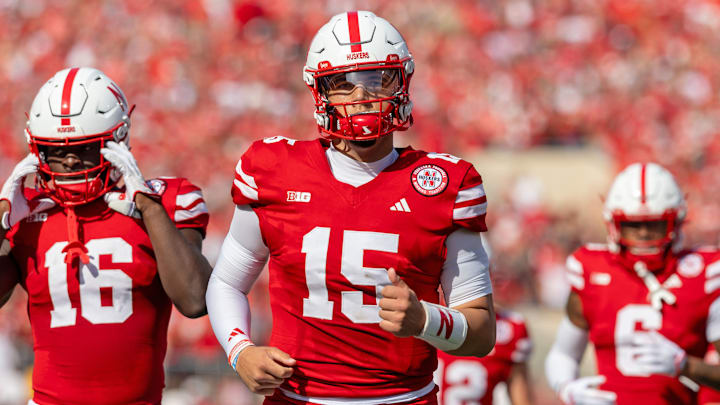 Husker players Dyaln Raiola (15) and Janiran Bonner (16) take the field against Rutgers.