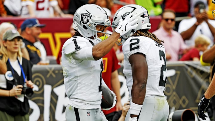 Sep 21, 2025; Landover, Maryland, USA; Las Vegas Raiders wide receiver Tre Tucker (1) celebrates with Las Vegas Raiders running back Ashton Jeanty (2) after scoring a touchdown during the second half against the Washington Commanders at Northwest Stadium. Mandatory Credit: Geoff Burke-Imagn Images