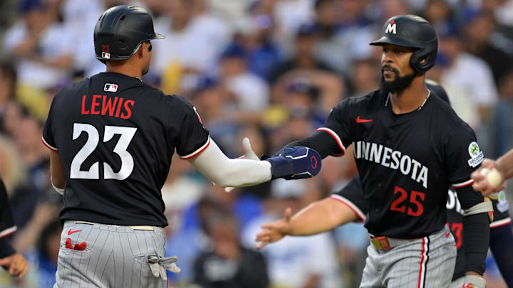 Jul 22, 2025; Los Angeles, California, USA; Minnesota Twins third base Royce Lewis (23) and outfielder Byron Buxton (25) react after scoring against the Los Angeles Dodgers in the first inning at Dodger Stadium. Jul 22, 2025; Los Angeles, California, USA; Minnesota Twins third base Royce Lewis (23) and outfielder Byron Buxton (25) react after scoring against the Los Angeles Dodgers in the first inning at Dodger Stadium.