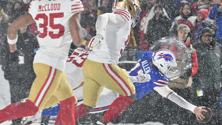 Buffalo Bills quarterback Josh Allen (17) reaches the ball across the goal line to score a touchdown against the San Francisco 49ers in the third quarter at Highmark Stadium. Buffalo Bills quarterback Josh Allen (17) reaches the ball across the goal line to score a touchdown against the San Francisco 49ers in the third quarter at Highmark Stadium.