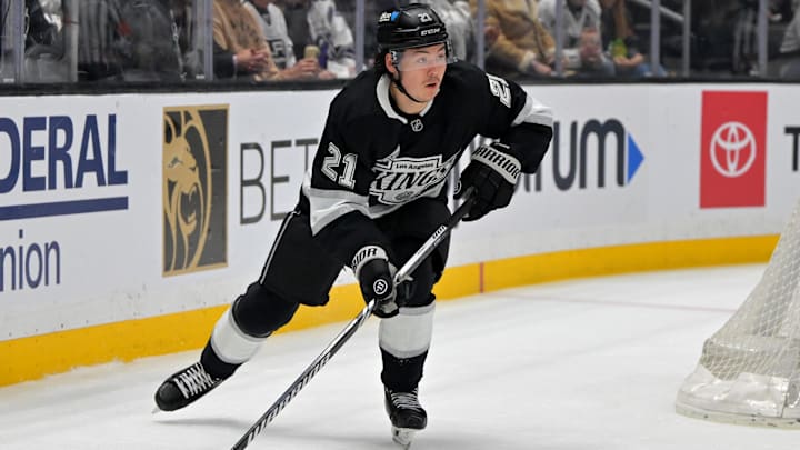 Apr 23, 2025; Los Angeles, California, USA; Los Angeles Kings defenseman Jordan Spence (21) handles the puck during game 2 of the 2025 Stanley Cup Playoffs against the Edmonton Oilers at Crypto.com Arena. Mandatory Credit: Jayne Kamin-Oncea-Imagn Images