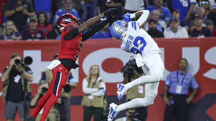 Nov 10, 2024; Houston, Texas, USA; Detroit Lions cornerback Carlton Davis III (23) intercepts a pass interned for Houston Texans wide receiver Tank Dell (3) during the third quarter at NRG Stadium. Mandatory Credit: Troy Taormina-Imagn Images