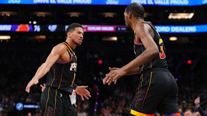 Mar 21, 2025; Phoenix, Arizona, USA; Phoenix Suns guard Devin Booker (1) and Phoenix Suns forward Kevin Durant (35) slap hands against the Cleveland Cavaliers during the second half at Footprint Center. Mandatory Credit: Joe Camporeale-Imagn Images