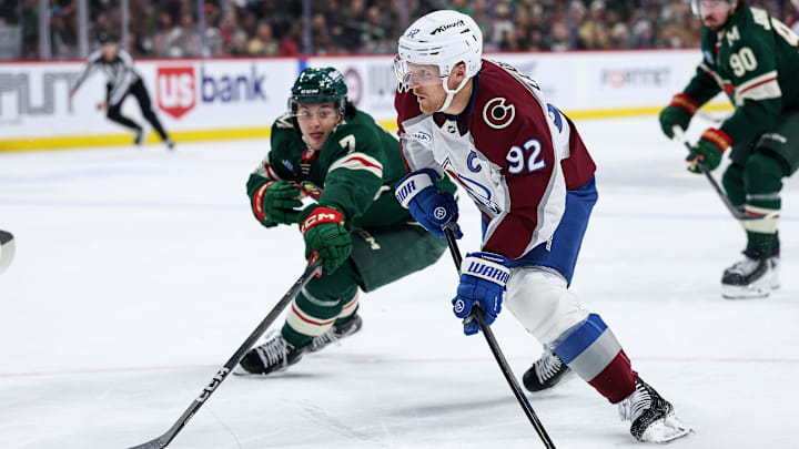 Nov 28, 2025; Saint Paul, Minnesota, USA; Colorado Avalanche left wing Gabriel Landeskog (92) shoots the puck as Minnesota Wild defenseman Brock Faber (7) defends during the third period at Grand Casino Arena. Mandatory Credit: Matt Krohn-Imagn Images Nov 28, 2025; Saint Paul, Minnesota, USA; Colorado Avalanche left wing Gabriel Landeskog (92) shoots the puck as Minnesota Wild defenseman Brock Faber (7) defends during the third period at Grand Casino Arena. Mandatory Credit: Matt Krohn-Imagn Images
