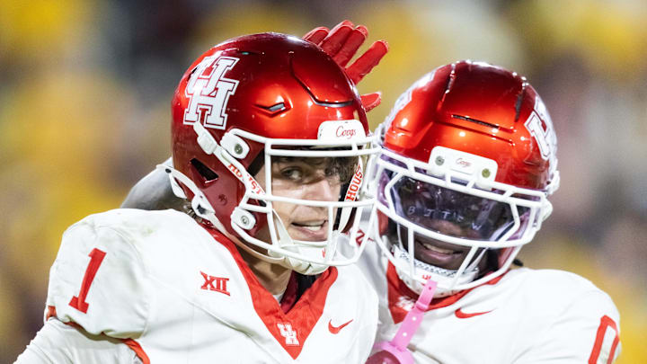 Oct 25, 2025; Tempe, Arizona, USA; Houston Cougars quarterback Conner Weigman (1) celebrates a touchdown with wide receiver Amare Thomas (0) against the Arizona State Sun Devils in the second half at Mountain America Stadium. Oct 25, 2025; Tempe, Arizona, USA; Houston Cougars quarterback Conner Weigman (1) celebrates a touchdown with wide receiver Amare Thomas (0) against the Arizona State Sun Devils in the second half at Mountain America Stadium.