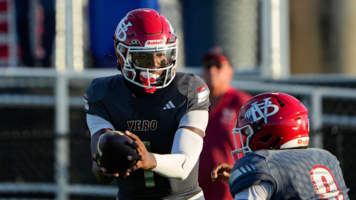 Vero Beach quarterback Champ Monds (1) hands off the ball to running back Jonathan Hillsman (8) in a preseason game against Miami Norland on Aug. 15. Last week, he passed for touchdown and ran for another score to help the Indians beat Eau Gallie, 41-31, in a battle of High School on SI Central Florida Top 10 teams. Vero Beach quarterback Champ Monds (1) hands off the ball to running back Jonathan Hillsman (8) in a preseason game against Miami Norland on Aug. 15. Last week, he passed for touchdown and ran for another score to help the Indians beat Eau Gallie, 41-31, in a battle of High School on SI Central Florida Top 10 teams.