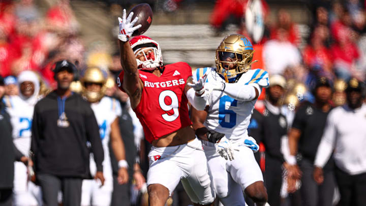 Oct 19, 2024; Piscataway, New Jersey, USA; Rutgers Scarlet Knights wide receiver Ian Strong (9) makes a catch as UCLA Bruins defensive back Jaylin Davies (6) defends during the first half at SHI Stadium. Mandatory Credit: Vincent Carchietta-Imagn Images