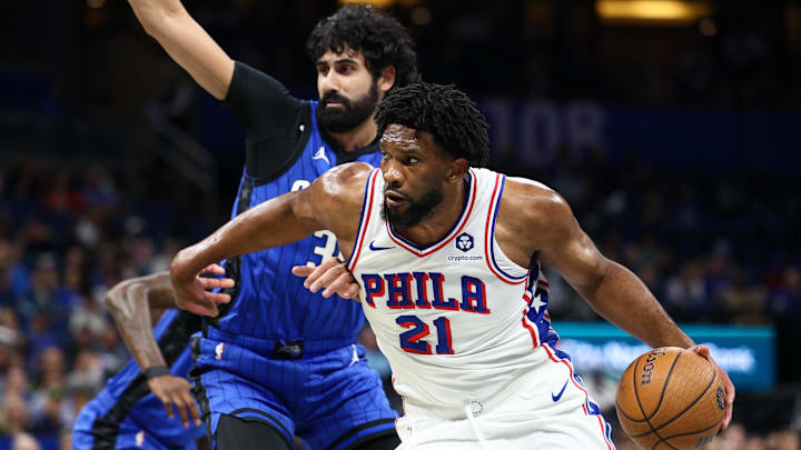 Nov 15, 2024; Orlando, Florida, USA; Philadelphia 76ers center Joel Embiid (21) drives to the basket past Orlando Magic center Goga Bitadze (35) in the first quarter at Kia Center. Mandatory Credit: Nathan Ray Seebeck-Imagn Images