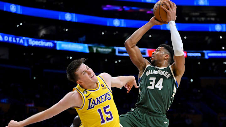 Feb 9, 2023; Los Angeles, California, USA;  Los Angeles Lakers guard Austin Reaves (15) defends Milwaukee Bucks forward Giannis Antetokounmpo (34) as he drives to the basket in the first half at Crypto.com Arena. Mandatory Credit: Jayne Kamin-Oncea-Imagn Images