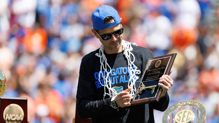 Apr 12, 2025; Gainesville, FL, USA; Florida Gators head coach Todd Golden holds the City of Gainesville Key to the City during the National Championship celebration at Ben Hill Griffin Stadium. Mandatory Credit: Matt Pendleton-Imagn Images