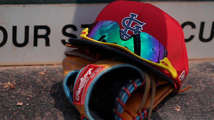 Mar 20, 2018; Jupiter, FL, USA; A St. Louis Cardinals hat with sunglasses sits on a glove in the dugout during a spring training game against the New York Mets at Roger Dean Stadium. Mandatory Credit: Jasen Vinlove-Imagn Images