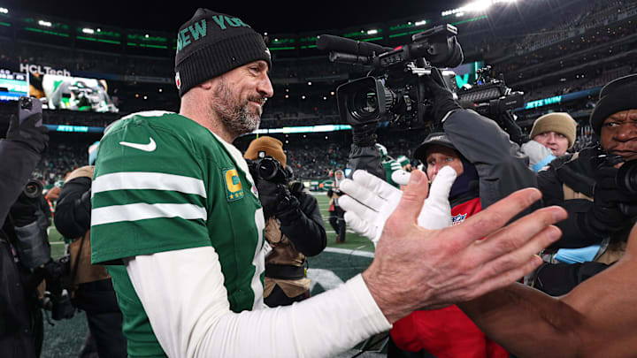Jan 5, 2025; East Rutherford, New Jersey, USA; New York Jets quarterback Aaron Rodgers (8) shakes hands with a Miami Dolphins player after the game at MetLife Stadium. Mandatory Credit: Vincent Carchietta-Imagn Images