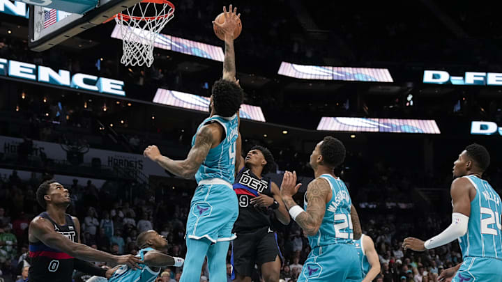 Oct 27, 2023; Charlotte, North Carolina, USA; Charlotte Hornets center Nick Richards (4) blocks a shot by Detroit Pistons forward Ausar Thompson (9) during the second half at Spectrum Center. Mandatory Credit: Jim Dedmon-Imagn Images