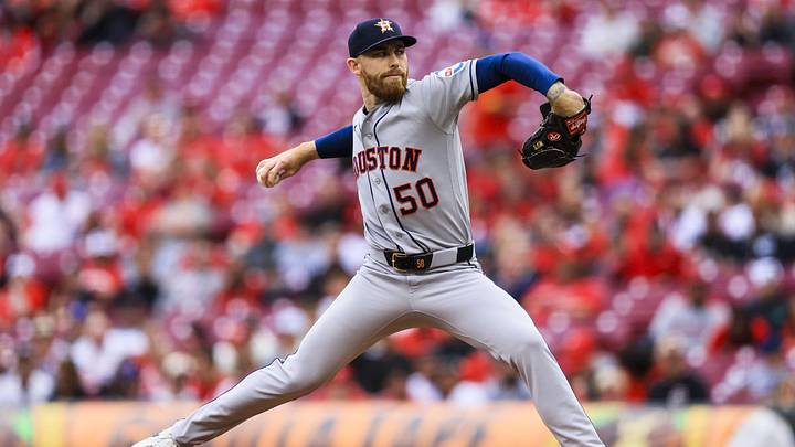 Mike Burrows throws a baseball in a grey Astros jerse
