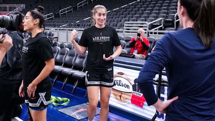 Former Iowa Hawkeyes Las Vegas Aces guard Kate Martin (20) and Indiana Fever guard Caitlin Clark (22) reunite Wednesday, Sept. 11, 2024, during a game between the Indiana Fever and the Las Vegas Aces at Gainbridge Fieldhouse in Indianapolis.