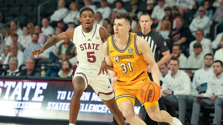 Feb 1, 2025; Starkville, Mississippi, USA; Missouri Tigers guard Caleb Grill (31) drives to the basket against Mississippi State Bulldogs guard Shawn Jones Jr. (5) during the first half at Humphrey Coliseum. Mandatory Credit: Wesley Hale-Imagn Images