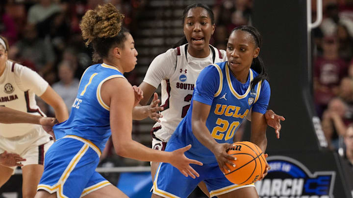 Mar 25, 2023; Greenville, SC, USA; UCLA Bruins guard Charisma Osborne (20) passes the ball to guard Kiki Rice (1) against the South Carolina Gamecocks during the second half of the NCAA Women s Tournament at Bon Secours Wellness Arena. Mandatory Credit: Jim Dedmon-Imagn Images