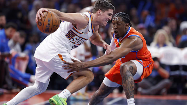 Nov 28, 2025; Oklahoma City, Oklahoma, USA; Phoenix Suns guard Collin Gillespie (12) moves the ball as Oklahoma City Thunder guard Jalen Williams (8) defends during the second half at Paycom Center. Mandatory Credit: Alonzo Adams-Imagn Images