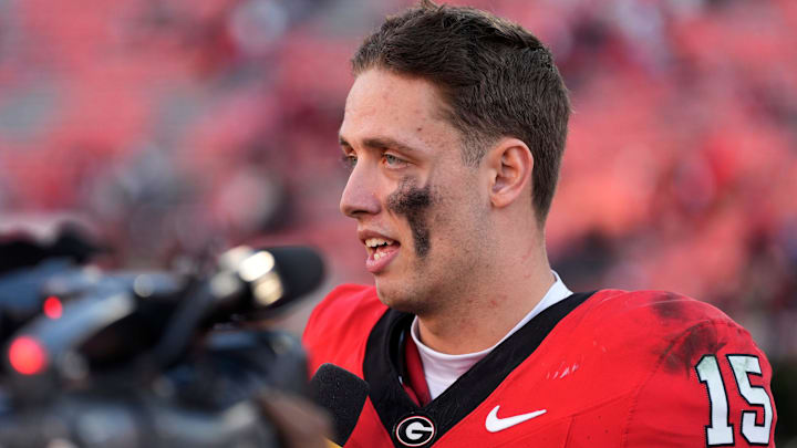 Georgia quarterback Carson Beck (15) speaks with the media after a NCAA college football game against Massachusetts in Athens, Ga.