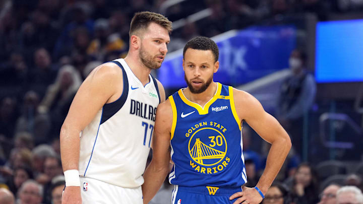 Dec 15, 2024; San Francisco, California, USA; Dallas Mavericks guard Luka Doncic (77) talks to Golden State Warriors guard Stephen Curry (30) during the first quarter at Chase Center. Mandatory Credit: Darren Yamashita-Imagn Images