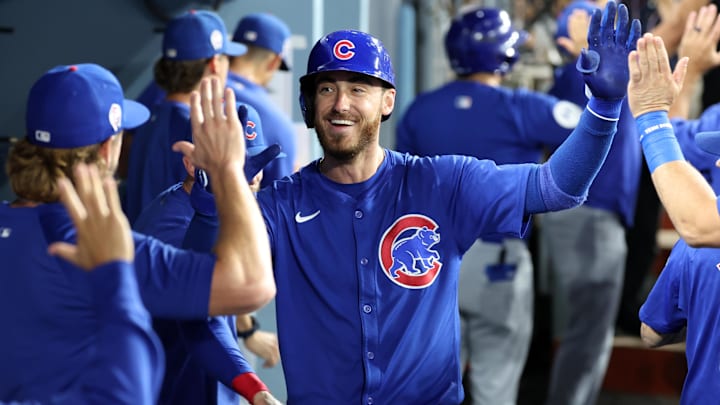 Sep 11, 2024; Los Angeles, California, USA;  Chicago Cubs right fielder Cody Bellinger (24) is greeted in the dugout after hitting a 3-run home run during the fifth inning against the Los Angeles Dodgers at Dodger Stadium.
