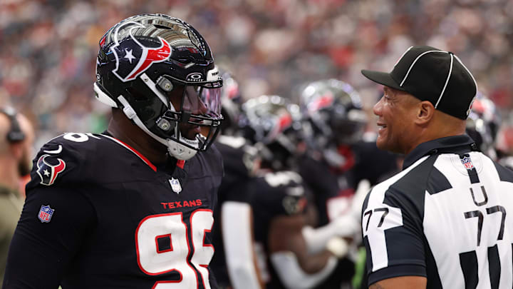 Nov 9, 2025; Houston, Texas, USA; Houston Texans defensive end Denico Autry (96) talks with umpire Terry Killens (77) during the second half of a game against the Jacksonville Jaguars  at NRG Stadium. Mandatory Credit: Thomas Shea-Imagn Images
