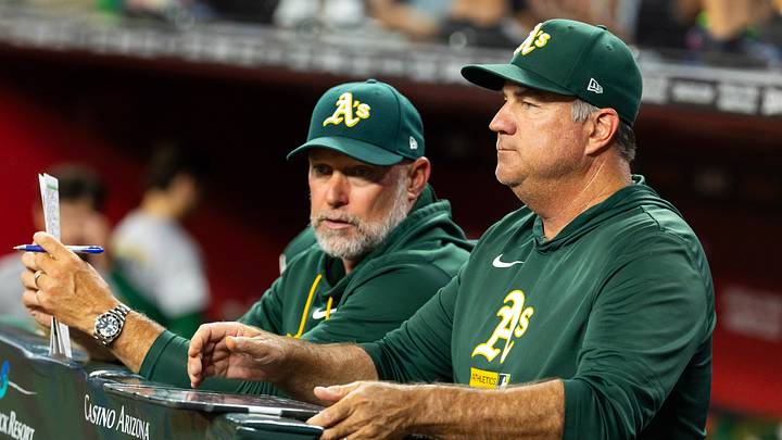 Jul 21, 2026; Phoenix, Arizona, USA; Athletics pitching coach Dan Hubbs (right) with manager Mark Kotsay against the Arizona Diamondbacks at Chase Field. Mandatory Credit: Mark J. Rebilas-Imagn Images Jul 21, 2026; Phoenix, Arizona, USA; Athletics pitching coach Dan Hubbs (right) with manager Mark Kotsay against the Arizona Diamondbacks at Chase Field. Mandatory Credit: Mark J. Rebilas-Imagn Images