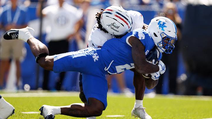 Sep 26, 2026; Lexington, Kentucky, USA; Kentucky Wildcats running back Jovantae Barnes (2) dives into the end zone for a touchdown against South Alabama Jaguars defensive back Jayvon Henderson (2) during the second quarter at Kroger Field. Mandatory Credit: Jordan Prather-Imagn Images Sep 26, 2026; Lexington, Kentucky, USA; Kentucky Wildcats running back Jovantae Barnes (2) dives into the end zone for a touchdown against South Alabama Jaguars defensive back Jayvon Henderson (2) during the second quarter at Kroger Field. Mandatory Credit: Jordan Prather-Imagn Images