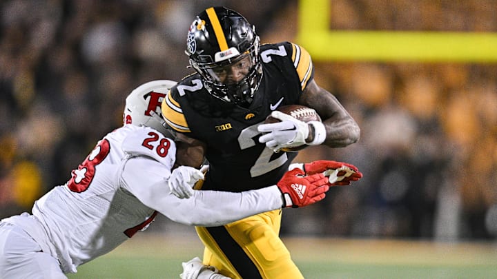 Nov 11, 2023; Iowa City, Iowa, USA; Iowa Hawkeyes running back Kaleb Johnson (2) runs the ball as Rutgers Scarlet Knights linebacker Dariel Djabome (28) goes for the tackle during the fourth quarter at Kinnick Stadium. Mandatory Credit: Jeffrey Becker-USA TODAY Sports