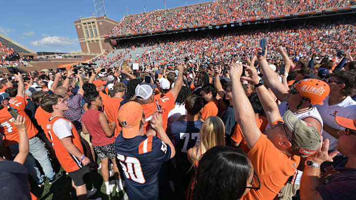 Sep 27, 2025; Champaign, Illinois, USA;  Fans flood the field after a 34-32 Illinois fighting Illini win over the Southern California Trojans at Memorial Stadium. Mandatory Credit: Ron Johnson-Imagn Images
