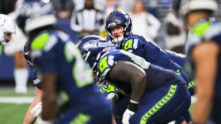 Dec 14, 2025; Seattle, Washington, USA; Seattle Seahawks quarterback Sam Darnold (14) stands over center against the Indianapolis Colts during the fourth quarter at Lumen Field. Mandatory Credit: Steven Bisig-Imagn Images