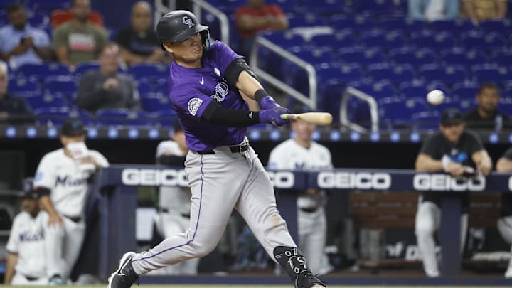 Jun 2, 2025; Miami, Florida, USA;  Colorado Rockies first baseman Keston Hiura (7) hits a double against the Miami Marlins during the ninth inning at loanDepot Park. Mandatory Credit: Rhona Wise-Imagn Images