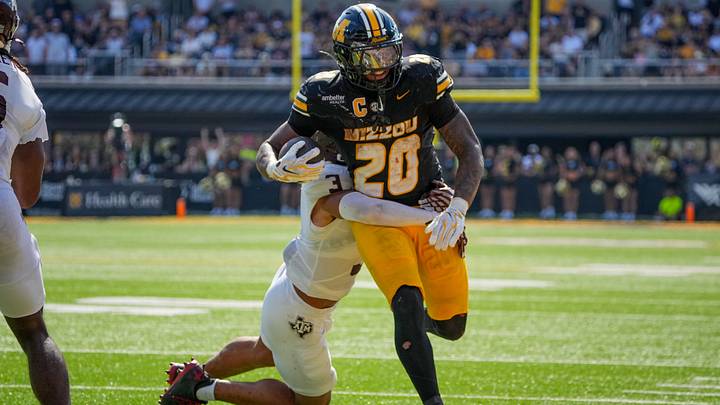Oct 10, 2026; Columbia, Missouri, USA; Missouri Tigers running back Jamal Roberts (20) runs the ball as Texas A&M Aggies safety Marcus Ratcliffe (3) makes the tackle during the second half of the game at Faurot Field at Memorial Stadium. Mandatory Credit: Denny Medley-Imagn Images