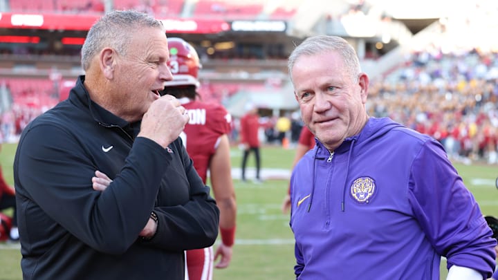 Oct 19, 2024; Fayetteville, Arkansas, USA; Arkansas Razorbacks head coach Sam Pittman talks to LSU Tigers head coach Brian Kelly prior to a game at Donald W. Reynolds Razorback Stadium. Mandatory Credit: Nelson Chenault-Imagn Images