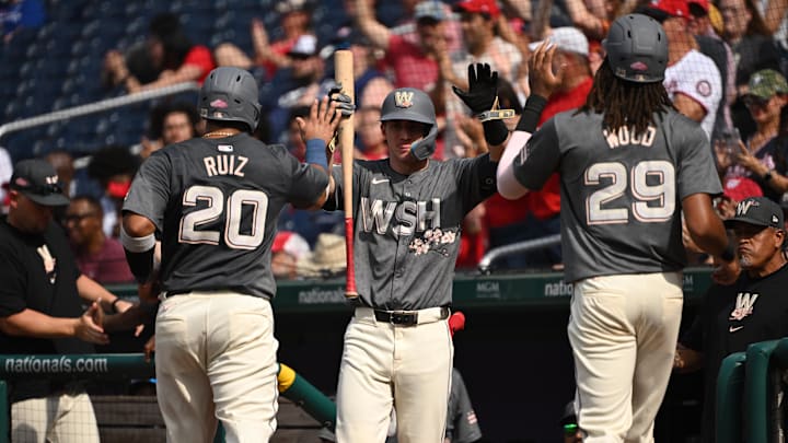 Aug 3, 2024; Washington, District of Columbia, USA; Washington Nationals catcher Keibert Ruiz (20) and center fielder James Wood (29) celebrate scoring two runs with center fielder Jacob Young (30) at Nationals Park.