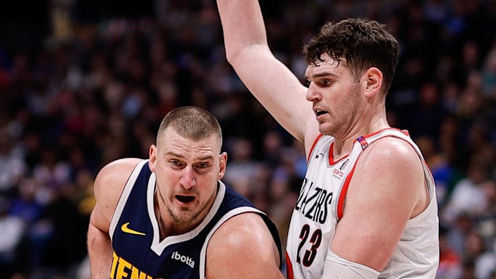 Feb 12, 2025; Denver, Colorado, USA: Denver Nuggets center Nikola Jokic (15) is fouled by Portland Trail Blazers center Donovan Clingan (23) in the third quarter at Ball Arena. Mandatory Credit: Isaiah J. Downing-Imagn Images