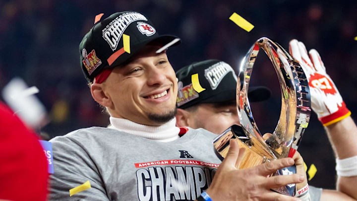 Kansas City Chiefs quarterback Patrick Mahomes celebrates with the Lamar Hunt Trophy after defeating the Buffalo Bills during the AFC Championship game at GEHA Field at Arrowhead Stadium. 