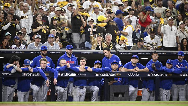 Sep 30, 2026; San Diego, California, USA;  San Diego Padres fans cheer behind the Chicago Cubs dugout in the ninth inning during game two of the Wildcard round for the 2026 MLB Playoffs at Petco Park.  Mandatory Credit: Denis Poroy-Imagn Images
