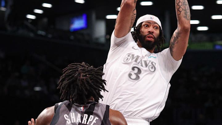Mar 24, 2025; Brooklyn, New York, USA; Dallas Mavericks forward Anthony Davis (3) passes the ball in front of Brooklyn Nets center Day'Ron Sharpe (20) during the second half at Barclays Center. Mandatory Credit: Vincent Carchietta-Imagn Images
