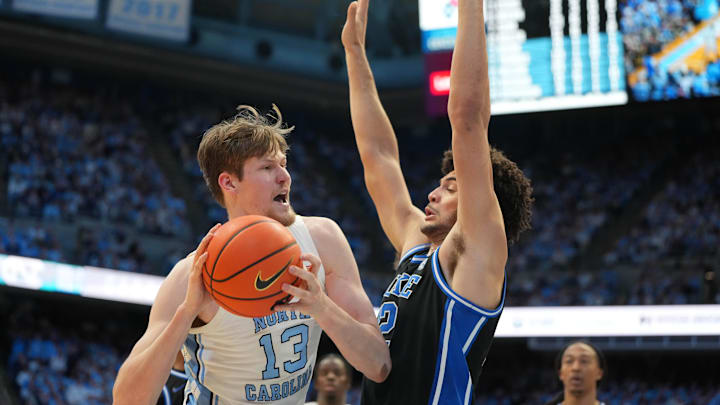 Feb 7, 2026; Chapel Hill, North Carolina, USA; North Carolina Tar Heels center Henri Veesaar (13) with the ball as Duke Blue Devils forward Cameron Boozer (12) defends in the second  half at Dean E. Smith Center. Mandatory Credit: Bob Donnan-Imagn Images