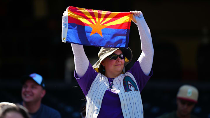 Sep 18, 2024; Denver, Colorado, USA; A fan of the Arizona Diamondbacks cheers before the game against the Colorado Rockies at Coors Field. Mandatory Credit: Ron Chenoy-Imagn Images