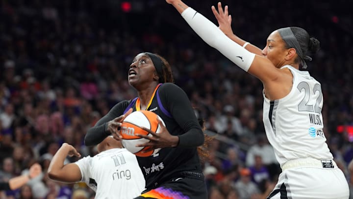 Oct 10, 2025; Phoenix, Arizona, USA; Phoenix Mercury guard Kahleah Copper (2) drives against Las Vegas Aces guard Dana Evans (11) and Las Vegas Aces center A'ja Wilson (22) during the second half of game four of the 2025 WNBA Finals at Mortgage Matchup Center. Mandatory Credit: Joe Camporeale-Imagn Images