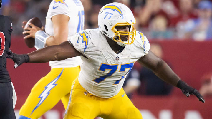Oct 21, 2024; Glendale, Arizona, USA; Los Angeles Chargers guard Zion Johnson (77) blocks for quarterback Justin Herbert against the Arizona Cardinals at State Farm Stadium. Mandatory Credit: Mark J. Rebilas-Imagn Images Oct 21, 2024; Glendale, Arizona, USA; Los Angeles Chargers guard Zion Johnson (77) blocks for quarterback Justin Herbert against the Arizona Cardinals at State Farm Stadium. Mandatory Credit: Mark J. Rebilas-Imagn Images