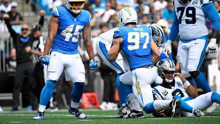 Sep 15, 2024; Charlotte, North Carolina, USA; Los Angeles Chargers linebacker Joey Bosa (97) sacks Carolina Panthers quarterback Bryce Young (9) as linebacker Tuli Tuipulotu (45) looks on in the third quarter at Bank of America Stadium. Mandatory Credit: Bob Donnan-Imagn Images