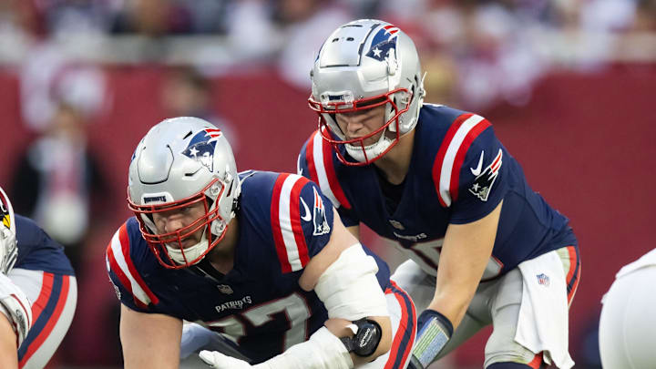 Dec 15, 2024; Glendale, Arizona, USA; New England Patriots center Ben Brown (77) prepares to snap the ball to quarterback Drake Maye (10) against the Arizona Cardinals at State Farm Stadium. Mandatory Credit: Mark J. Rebilas-Imagn Images